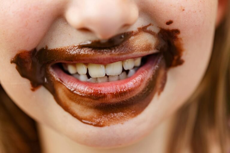 close up of smiling child mouth in chocolate