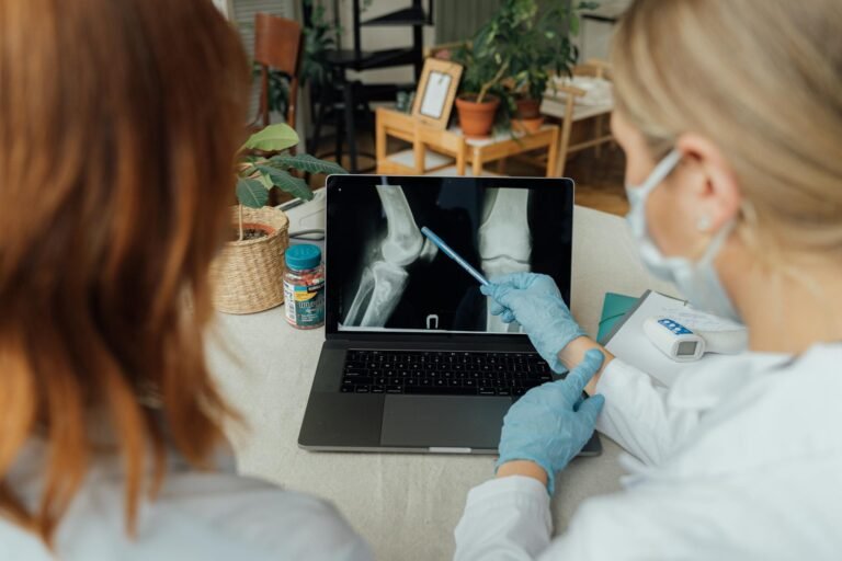 doctors examining an x ray image on a laptop